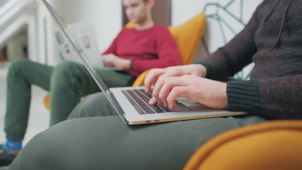 Colleagues Programmers Are Looking Monitor Typing Keyboard Office