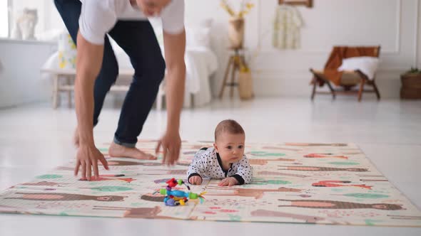 Happy Father with His One 7 Year Old Son Playing at Home