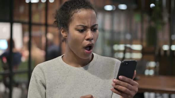 Upset African Woman Reacting to Loss on Phone