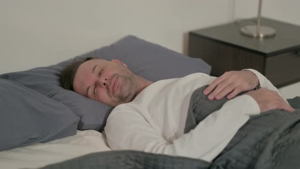 Relaxed Casual Man Sleeping in Bed Peacefully