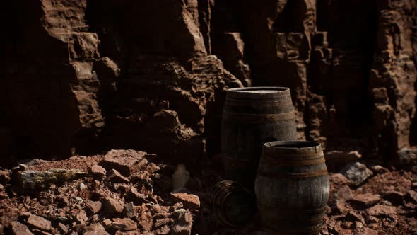 Old Wooden Vintage Wine Barrels Near Stone Wall in Canyon alt
