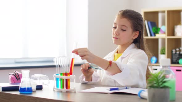 Girl with Magnifier and Beaker at Home Laboratory