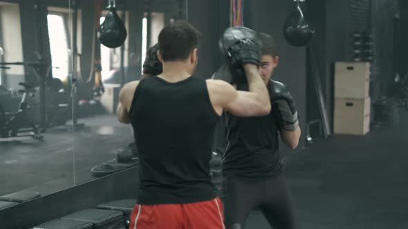 Athletic Man Fighting During the Training with Boxing Trainer at the Gym, Slow Motion