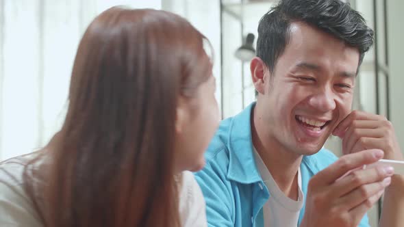 Close Up Happy Asian Couple After Checking A Pregnancy Test