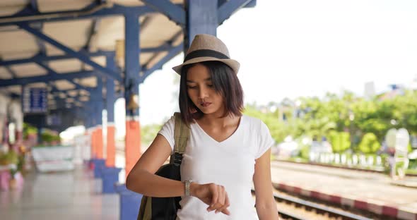 Woman walking and looking a watch