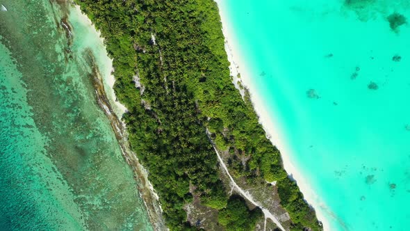 Tropical flying clean view of a summer white paradise sand beach and turquoise sea background 