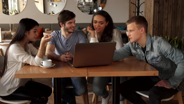 Young People Point Their Forefingers on Laptop Screen