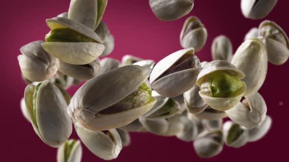 Flying of Pistachios in Deep Fuchsia Background