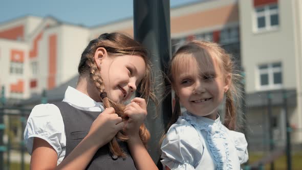 Two little girls talking at schoolyard