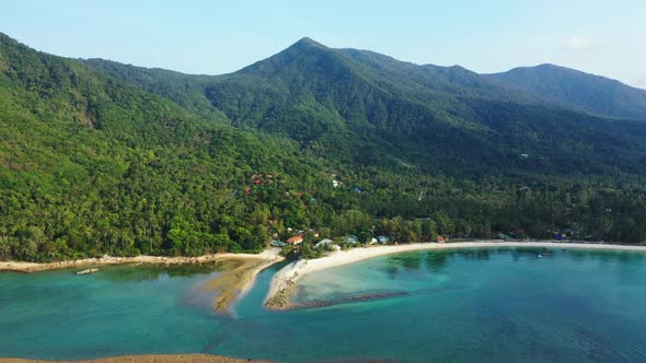 Aerial scenery of idyllic shore beach wildlife by blue ocean with clean sand background of a daytrip
