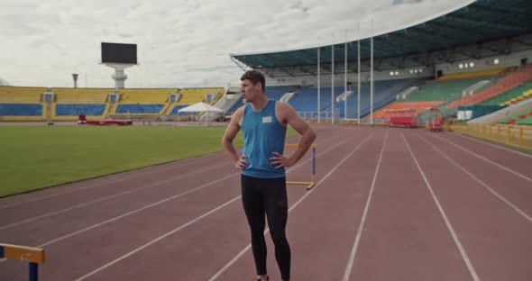 Runner Taking Break Near Hurdles