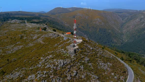 Aerial Circle Dolly View Of Telecommunications Mast On Rocky Hillside In Miradoiro da Curota