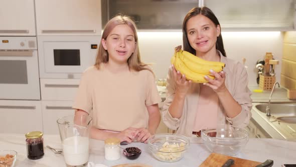 Mom And Daughter Cooking Homemade Dessert