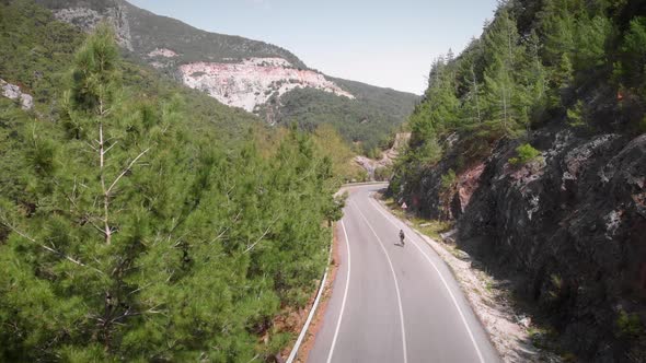 Cyclist cycling on mountain road. Road bike.