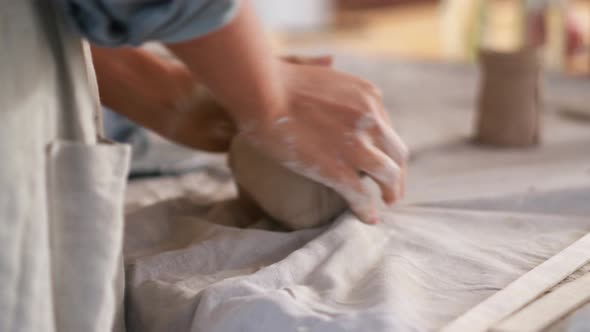 Woman potter knead clay