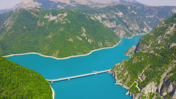 Aerial Topview on Bridge Over Lake Piva with Mountains Canyon in Montenegro