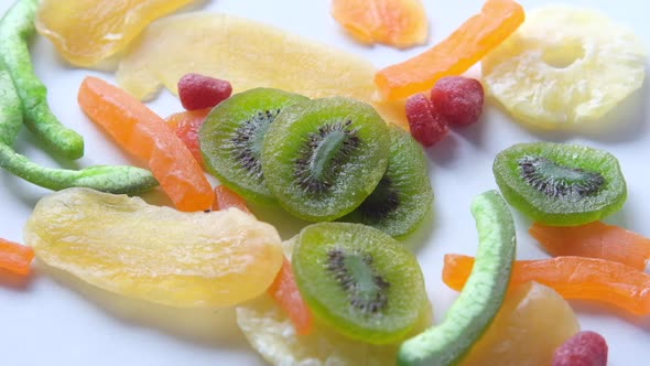 Dropping Dried Fruits and Berries on White Background