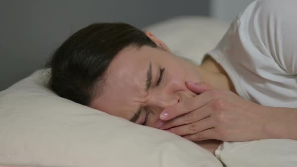 Upset Young Woman Crying in Bed