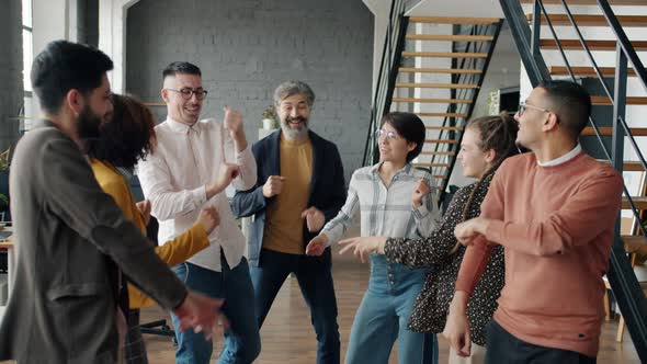 Slow Motion of People Business Team Dancing in Workplace Enjoying Party
