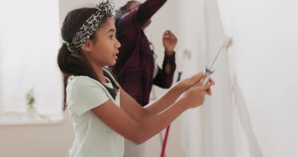 Busy Mom Spends Time with Cheerful Daughter Engages Her to Help Together They Painting the Walls of