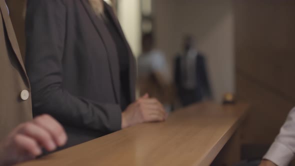 Unrecognizable Guests Checking Into Hotel