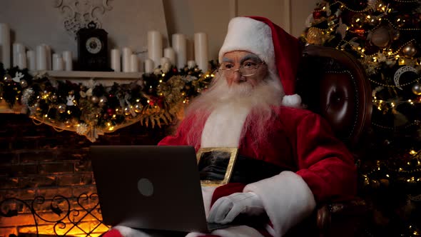 Modern Surprised Santa Claus Listens Children Online Webcam Laptop Video Call