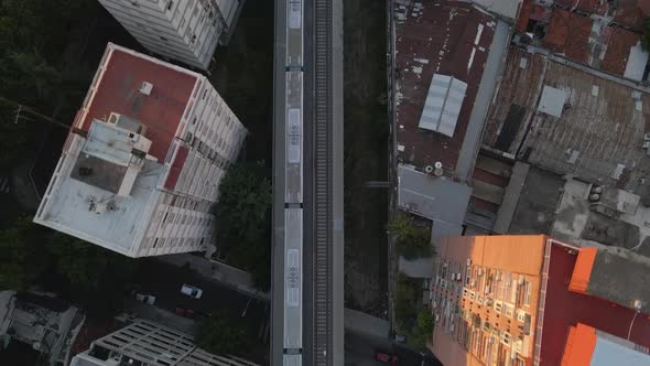 Aerial top down following training between Belgrano neighborhood buildings and houses, Buenos Aires,