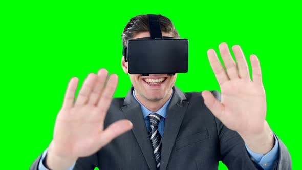 Happy businessman using virtual reality headset