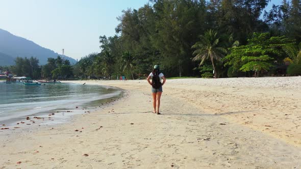 Women enjoying life on relaxing resort beach voyage by turquoise lagoon with clean sand background o