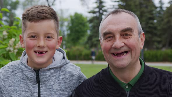 Toothless Grandfather and Grandson Are Laughing. Closeup.