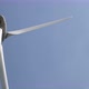 Wind turbine in operation against a background of blue sunny sky. the silhouette of the wind turbine - VideoHive Item for Sale