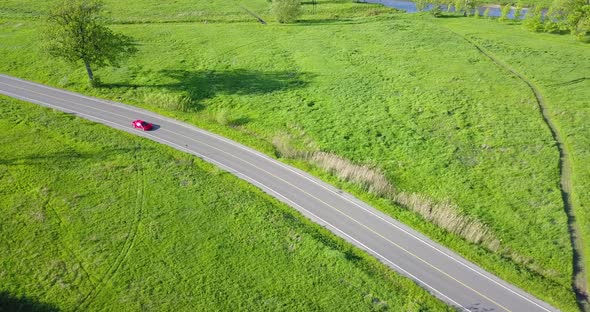 Aerial footage of Red Ferrari on the Road