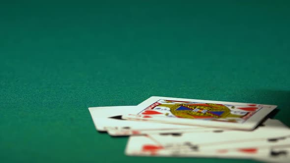 Playing Cards Falling on Desk After End of Poker Game, Excitement of Big Winning