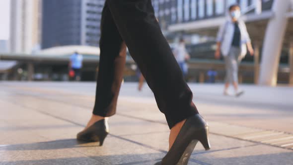 Legs of Young Businesswoman Walking