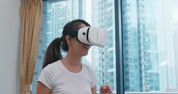 Woman watch on VR device at home