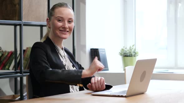 Smiling in Camera, Woman Typing on Laptop, Office