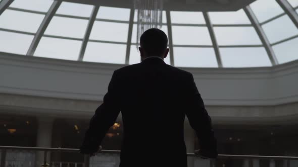 Businessman in a shopping center against the window.