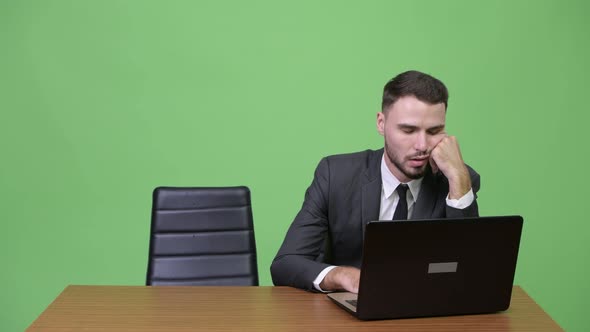 Young Businessman Falling Asleep with Young Businesswoman Getting Angry