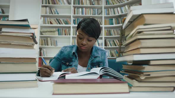 African Female Student Studying Making Some Notes From the Book 