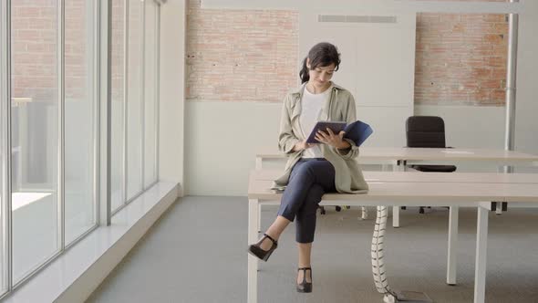 Businesswoman Working in the Office Sitting at the Table