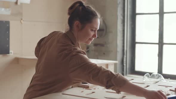 Young Female Joiner Working in Workshop