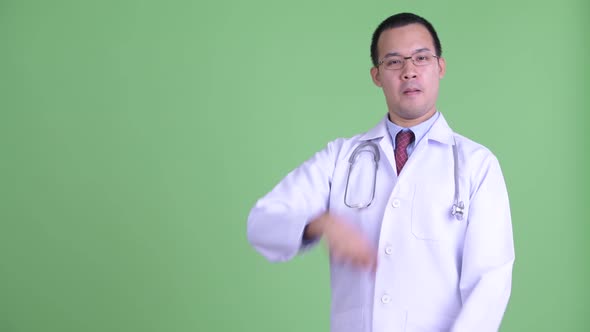 Happy Asian Man Doctor Touching Something