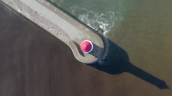 A Lighthouse and Breakwater at the Mouth of a Harbour in the UK