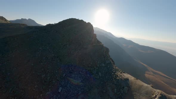 Aerial Panorama View Extreme Man Running on Stone Peak of High Mountain Sunset Sunrise Natural Glare