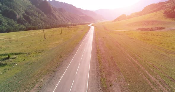 Flight Over Mountain Asphalt Highway Road and Meadow