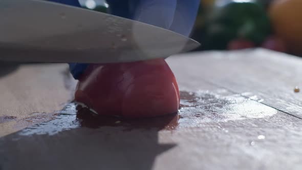 Tomato Cut By the Knife on the Cooking Board