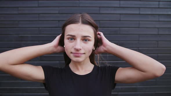 Charming Young Woman with a Magnificent Big Blue Eyes, She Turns To Camera and Smiles.