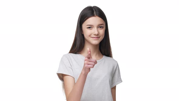 Portrait of Attractive Schoolgirl 1718 Years Old in Casual Tshirt Gesturing Finger on Camera with