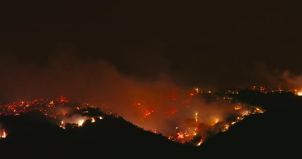 Cinematic View on a Fire at Night. Smoke Causes Air Pollution and Climate Change
