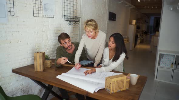 Three architects working together at desk